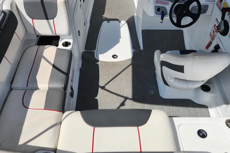 Slide: The Image of Interior of a 2021 Tahoe 1950 boat with seating and steering area. - 9