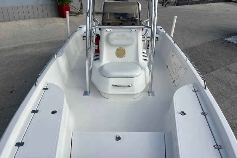 Slide: The Image of 2005 NauticStar 2200 Nautic Bay boat interior with seating and storage compartments. - 12
