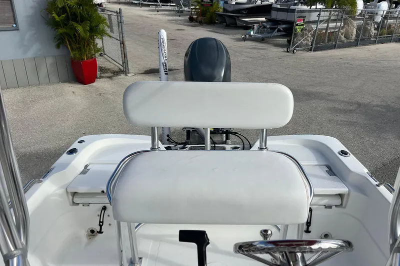 Slide: The Image of 2005 NauticStar 2200 Nautic Bay boat interior with white seating and steering wheel. - 13