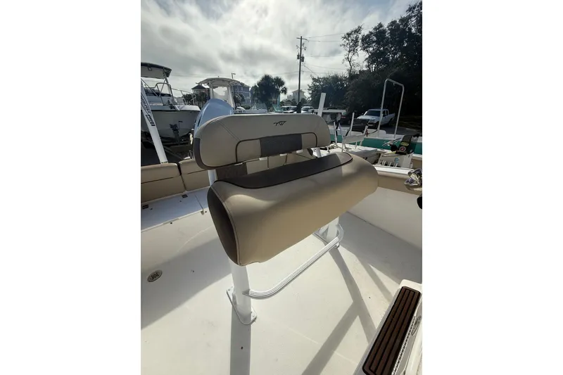Slide: The Image of 2019 Tidewater 210 LXF boat interior with tan seating and helm station. - 7