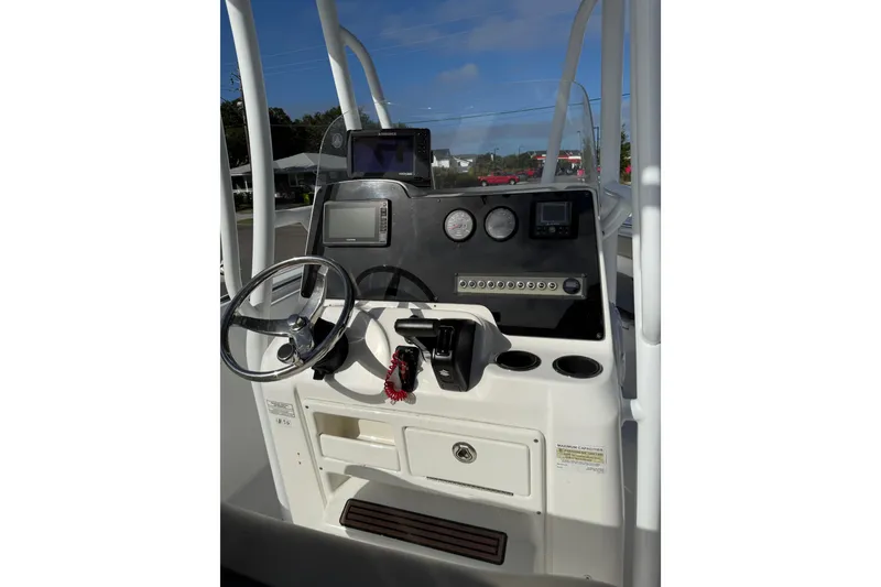 Slide: The Image of 2019 Tidewater 210 LXF boat console with steering wheel and navigation instruments. - 8