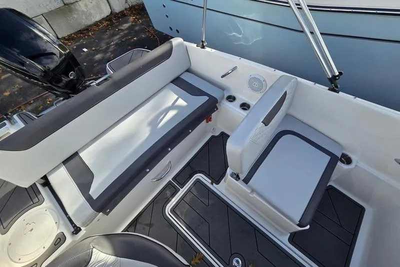 Slide: The Image of 2024 Bayliner M19 boat interior with seating and cup holders. - 13