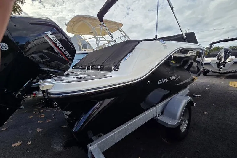 Slide: The Image of 2024 Bayliner M19 boat on trailer, featuring sleek black and white design. - 5