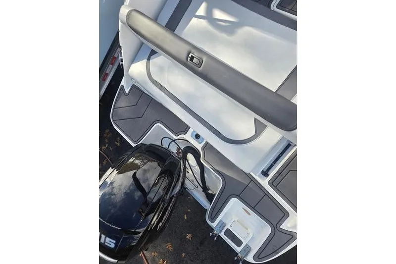 Slide: The Image of 2024 Bayliner M19 boat deck with motor, featuring sleek design and modern finishes. - 7