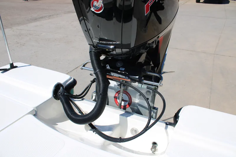 Slide: The Image of 2022 Mako 18 LTS boat engine detail with cables and connections. - 13