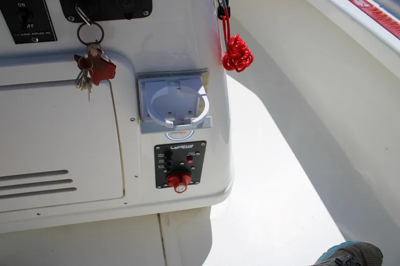 Slide: The Image of Control panel of a 2022 Mako 18 LTS boat with keys and safety switch. - 15