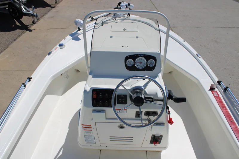 Slide: The Image of 2022 Mako 18 LTS boat interior with steering wheel and control panel. - 16