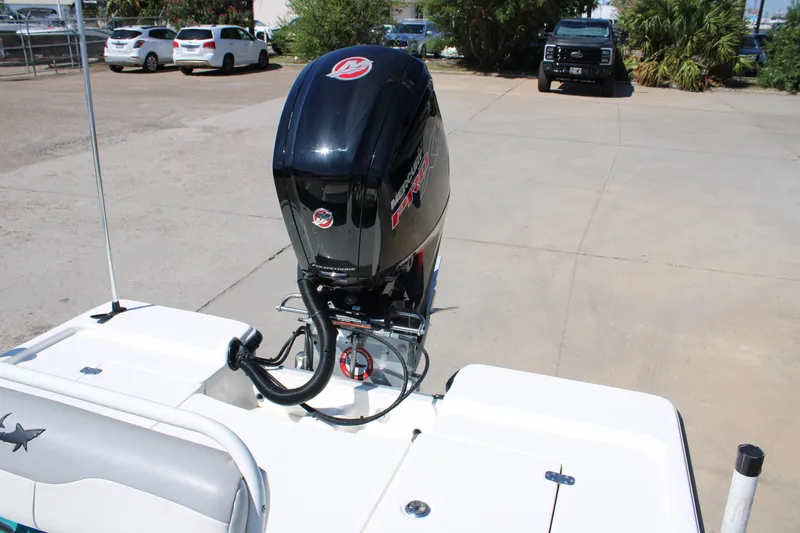 Slide: The Image of 2022 Mako 18 LTS boat with powerful outboard motor in a parking area. - 17