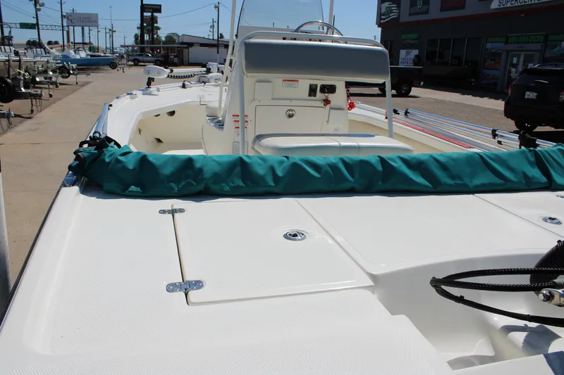 Slide: The Image of 2022 Mako 18 LTS boat on display at a dealership, showcasing deck and console. - 5