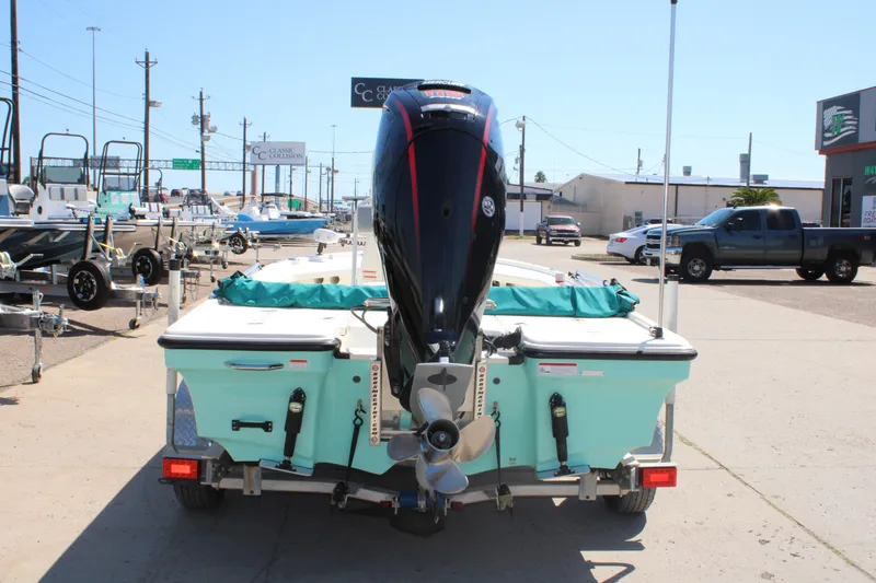 Slide: The Image of 2022 Mako 18 LTS boat on trailer, rear view with outboard motor, in a dealership lot. - 7