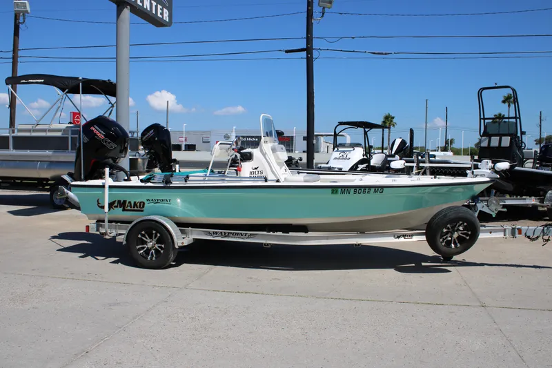 Slide: The Image of 2022 Mako 18 LTS boat on trailer, displayed outdoors under clear blue sky. - 9
