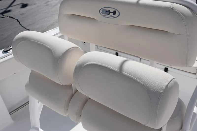 Slide: The Image of 2026 Sea Hunt Ultra 229 boat seating with white cushioned upholstery. - 10