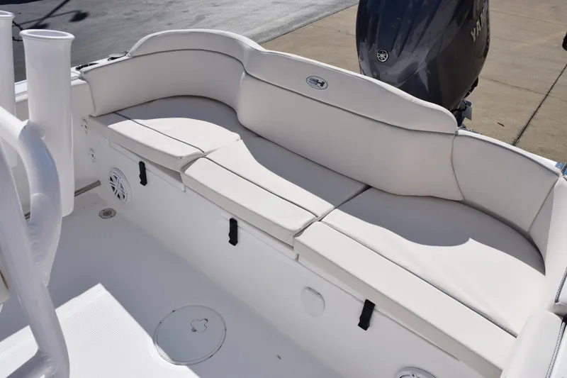 Slide: The Image of 2026 Sea Hunt Ultra 229 boat interior with white cushioned seating and Yamaha engine. - 11