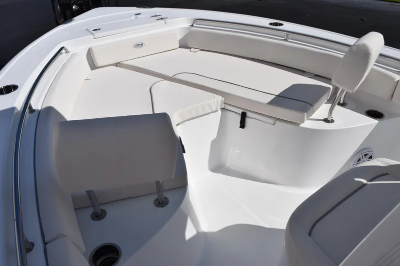 Slide: The Image of 2026 Sea Hunt Ultra 229 boat interior with white seating and sleek design. - 12