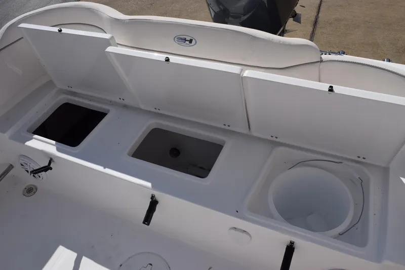 Slide: The Image of 2026 Sea Hunt Ultra 229 boat interior with storage compartments and seating. - 16