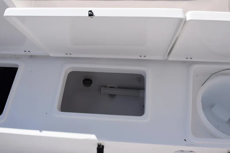 Slide: The Image of 2026 Sea Hunt Ultra 229 boat storage compartments, open and empty, showcasing interior design. - 17