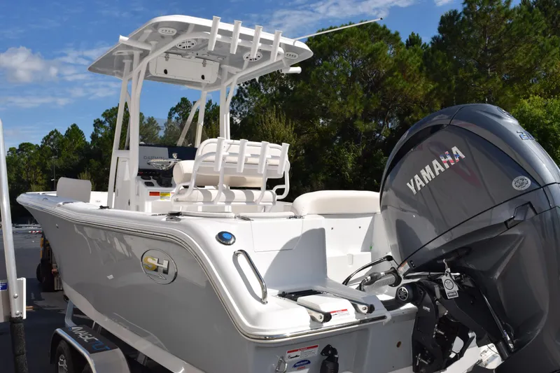 Slide: The Image of 2026 Sea Hunt Ultra 229 boat with Yamaha engine, parked outdoors. - 6