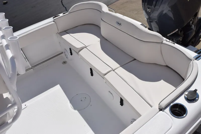 Slide: The Image of 2026 Sea Hunt Ultra 229 boat interior with cushioned seating and rod holders. - 7