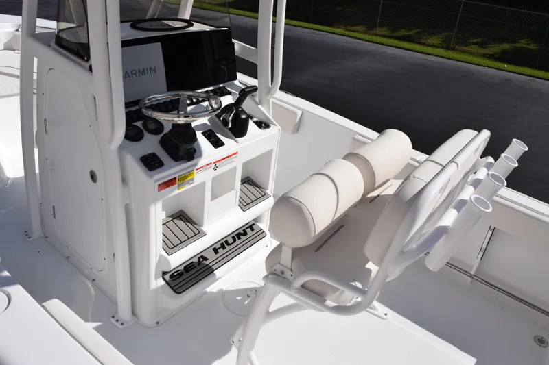 Slide: The Image of 2026 Sea Hunt Ultra 229 boat interior with steering console and seating. - 8