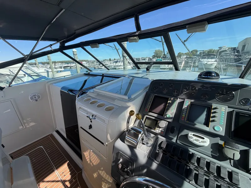 Slide: The Image of 1995 Tiara Yachts 3500 Express cockpit with navigation controls and marina view. - 10