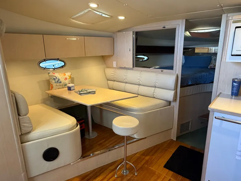 Slide: The Image of 1995 Tiara Yachts 3500 Express interior with cozy dining area and modern furnishings. - 16