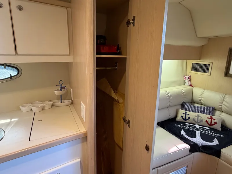 Slide: The Image of 1995 Tiara Yachts 3500 Express interior with cozy seating and nautical decor. - 23