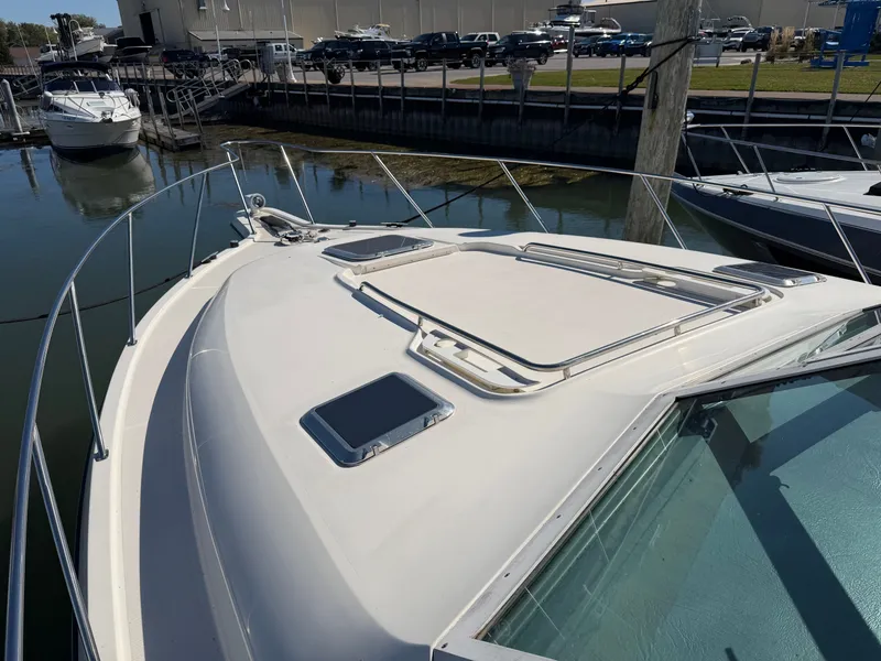 Slide: The Image of 1995 Tiara Yachts 3500 Express docked, showcasing sleek deck design and marina setting. - 26