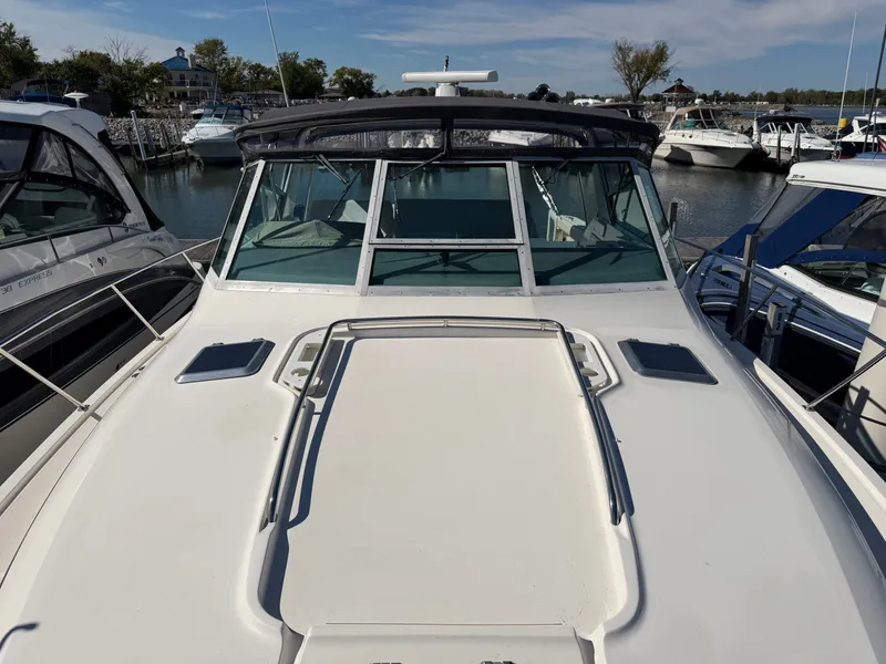 Slide: The Image of 1995 Tiara Yachts 3500 Express docked at a marina, surrounded by other boats. - 28