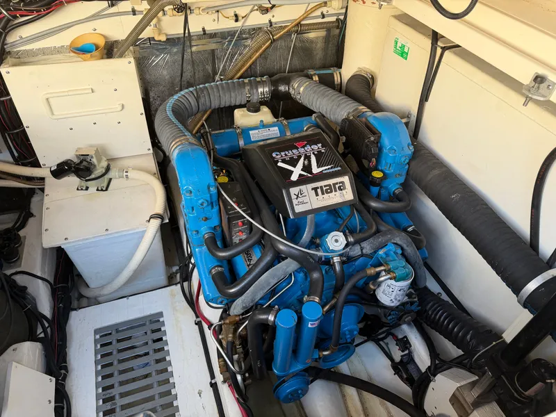 Slide: The Image of Engine compartment of a 1995 Tiara Yachts 3500 Express, featuring a Crusader XL engine. - 32