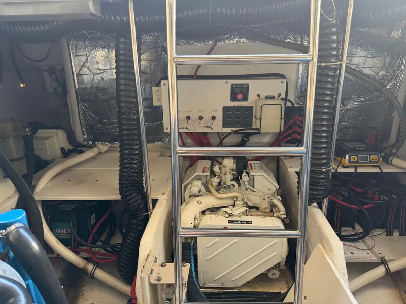 Slide: The Image of Engine room of a 1995 Tiara Yachts 3500 Express, featuring mechanical components and wiring. - 36