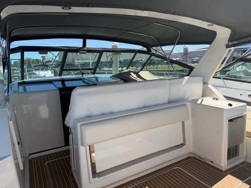 Slide: The Image of 1995 Tiara Yachts 3500 Express interior with seating and helm, featuring sleek design and modern amenities. - 38