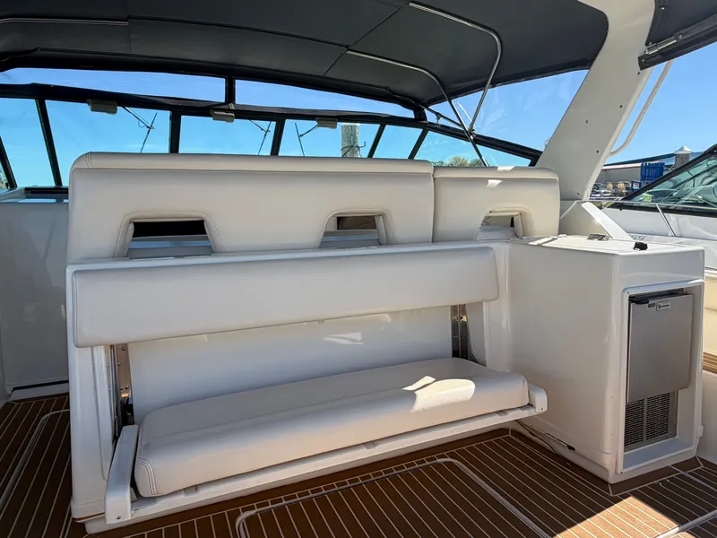 Slide: The Image of 1995 Tiara Yachts 3500 Express interior with white seating and wooden flooring. - 5