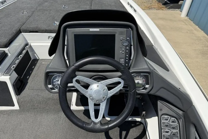 Slide: The Image of 2014 Skeeter FX20 boat storage compartment with open lid, showcasing interior space. - 14