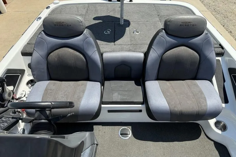 Slide: The Image of 2014 Skeeter FX20 boat interior with storage compartment and carpeted flooring. - 18
