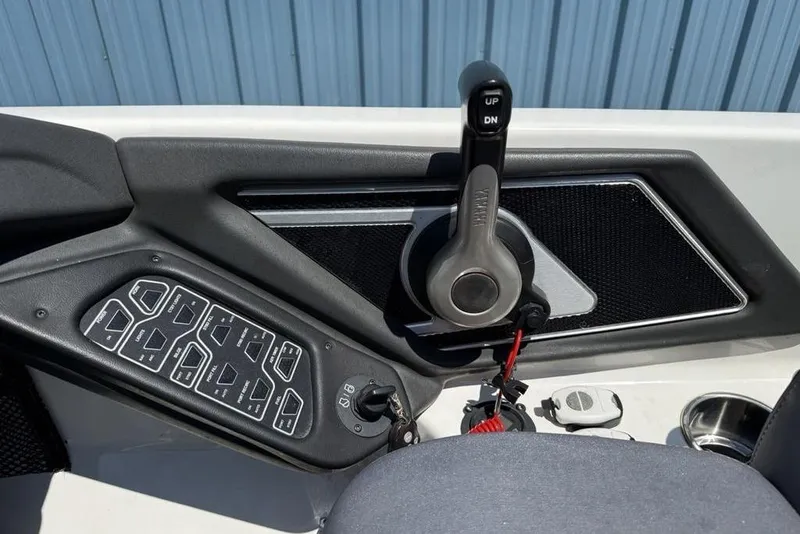 Slide: The Image of 2014 Skeeter FX20 boat storage compartment with carpeted interior and hydraulic lift. - 19