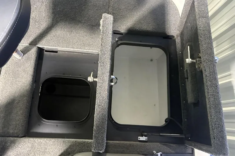 Slide: The Image of 2014 Skeeter FX20 boat storage compartments with open hatches, showcasing interior space. - 30
