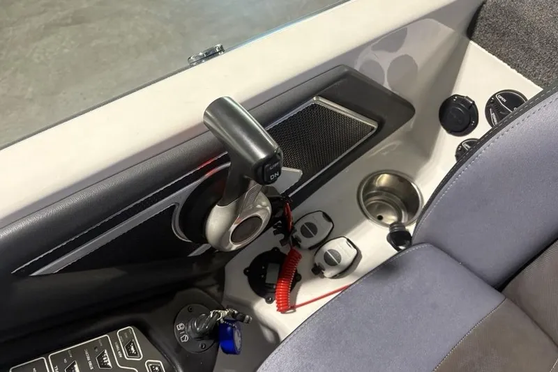 Slide: The Image of 2014 Skeeter FX20 boat console with controls, cup holder, and ignition key. - 33