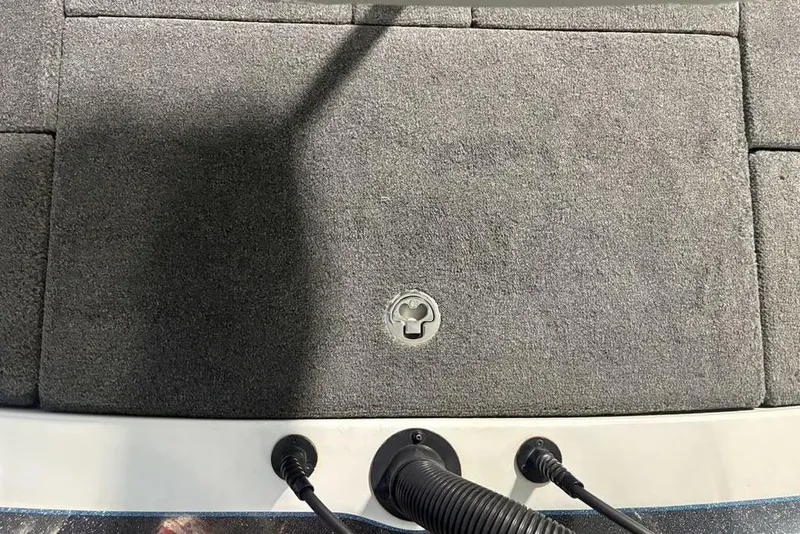 Slide: The Image of 2014 Skeeter FX20 boat deck with gray carpet and storage hatch. - 34