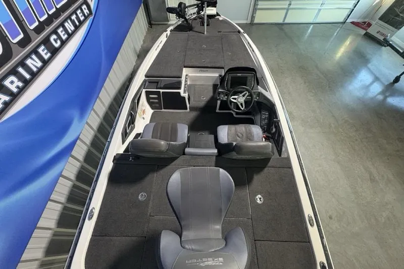 Slide: The Image of 2014 Skeeter FX20 boat interior with steering console and seating, displayed indoors. - 35
