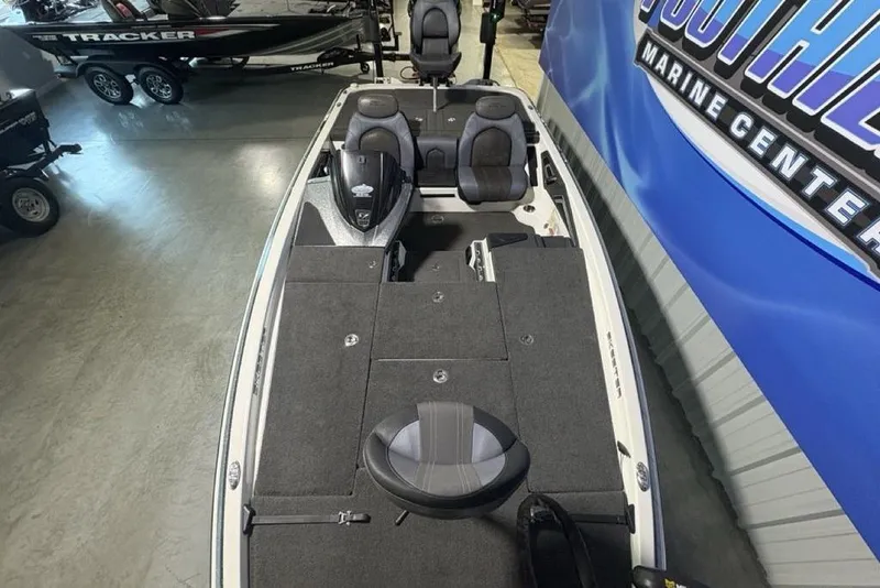Slide: The Image of 2014 Skeeter FX20 bass boat in showroom, featuring spacious deck and seating. - 36