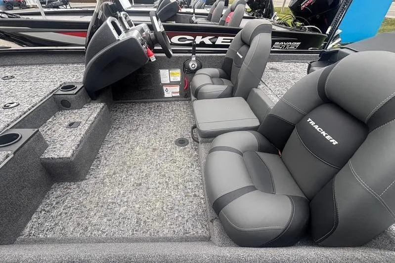 Slide: The Image of 2026 Tracker Pro Team 175 boat interior with gray seating and steering console. - 10