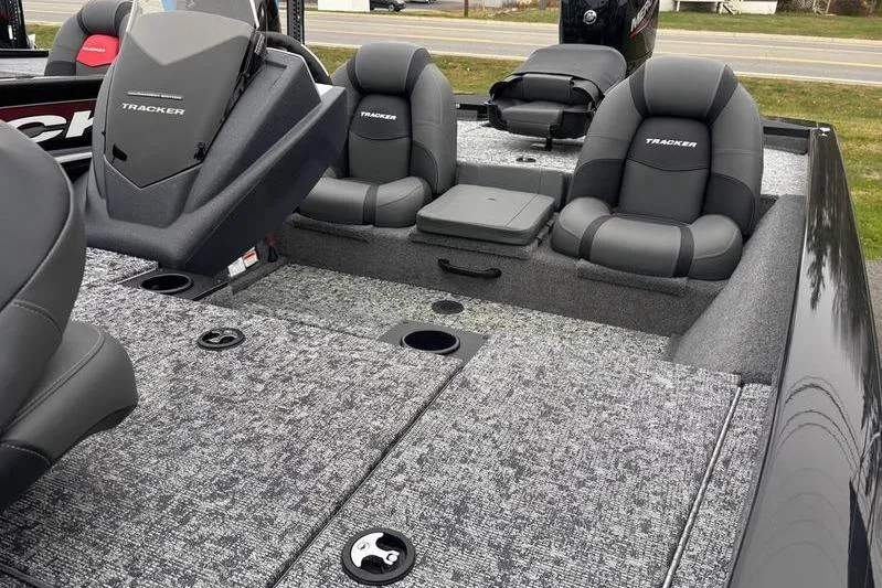 Slide: The Image of 2026 Tracker Pro Team 175 boat interior with gray seating and carpeted deck. - 12