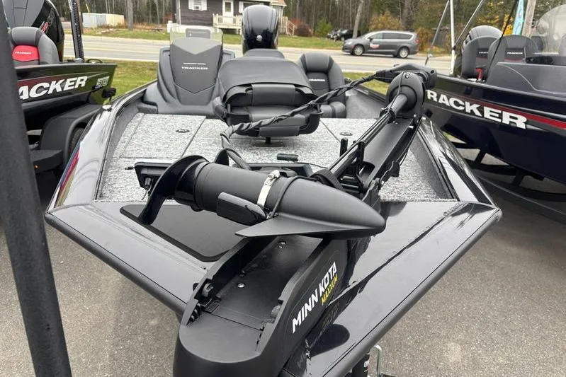 Slide: The Image of 2026 Tracker Pro Team 175 boat with Minn Kota trolling motor, parked outdoors. - 4