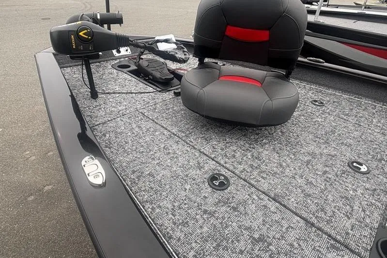 Slide: The Image of 2026 Tracker Pro Team 175 boat interior with gray carpet and black-red seat. - 9