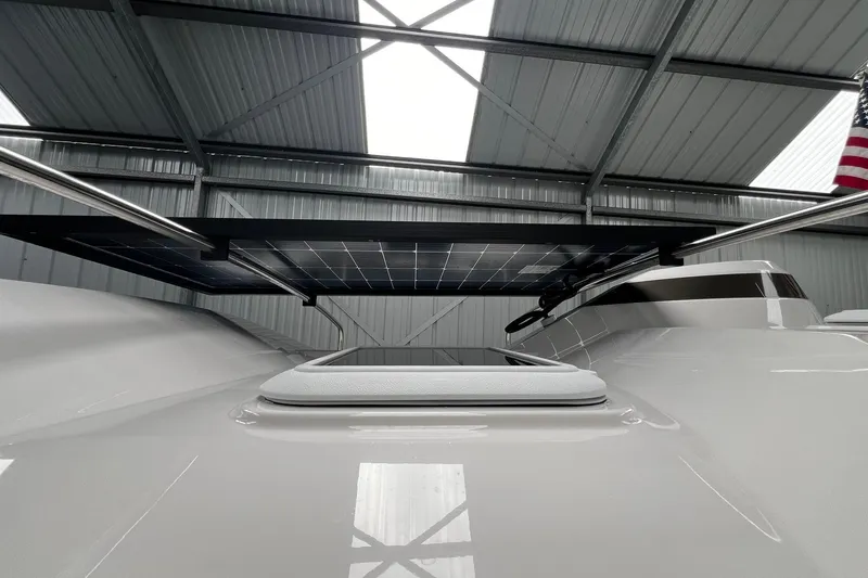 Slide: The Image of 2025 Ranger Tugs R-27 boat with solar panel under a metal roof. - 13