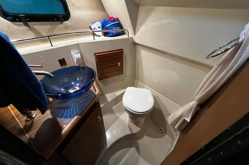Slide: The Image of 2025 Ranger Tugs R-27 boat bathroom with modern sink and toilet. - 23