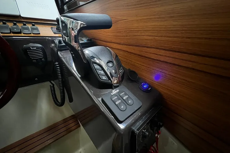 Slide: The Image of Control panel of 2025 Ranger Tugs R-27 boat with throttle and navigation controls. - 27