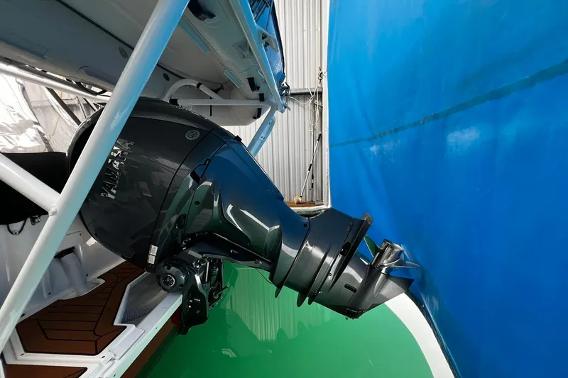 Slide: The Image of 2025 Ranger Tugs R-27 boat with Yamaha outboard motor in a storage facility. - 7