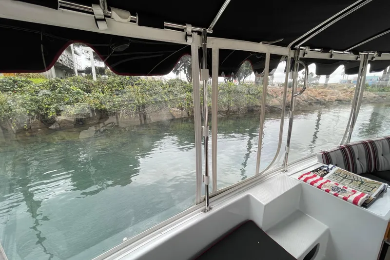 Slide: The Image of Interior view of 2020 Duffy Snug Harbor 18 boat with water and greenery outside. - 11