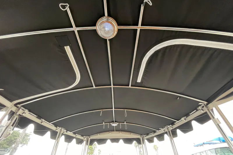 Slide: The Image of Interior view of 2020 Duffy Snug Harbor 18 boat canopy with metal framework. - 16